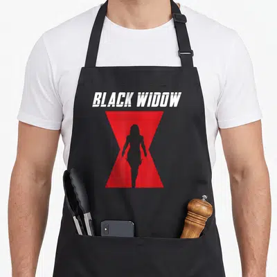 Silhouette black apron - Black Widow text above red hourglass containing black female silhouette holding batons — shown on a black cotton canvas apron against a white background