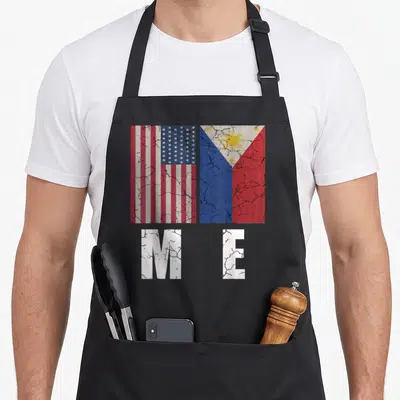 Filipino pride american flag apron - Two distressed flags above white M E letters in red white blue and yellow — shown on a black cotton canvas apron against a white background