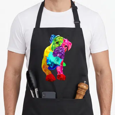 Colorful boxer dog apron - Multicolored cartoon boxer puppy in red blue yellow green purple and pink — shown on a black cotton canvas apron against a white background