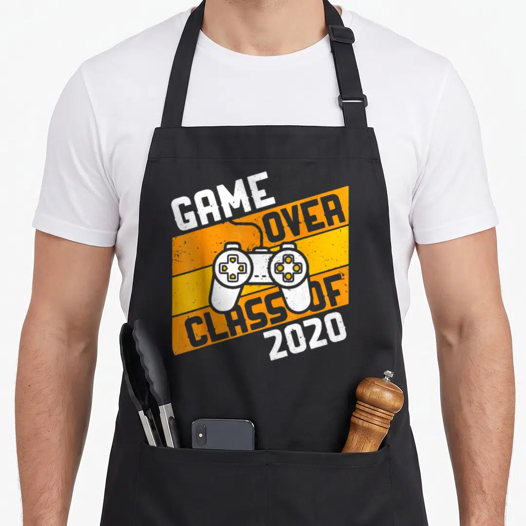 Class video game apron - White game controller over orange stripes with Game Over Class of 2020 text — shown on a black cotton canvas apron against a white background