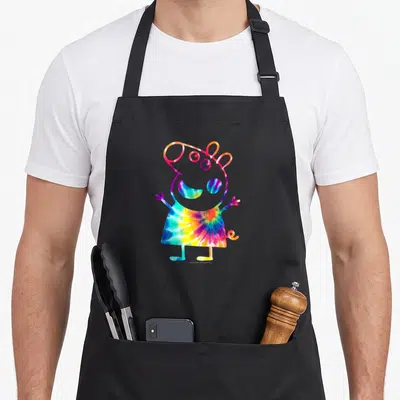 Portrait tie-dye apron - Tie-dye pig silhouette in blue yellow red and purple on black fabric — shown on a black cotton canvas apron against a white background
