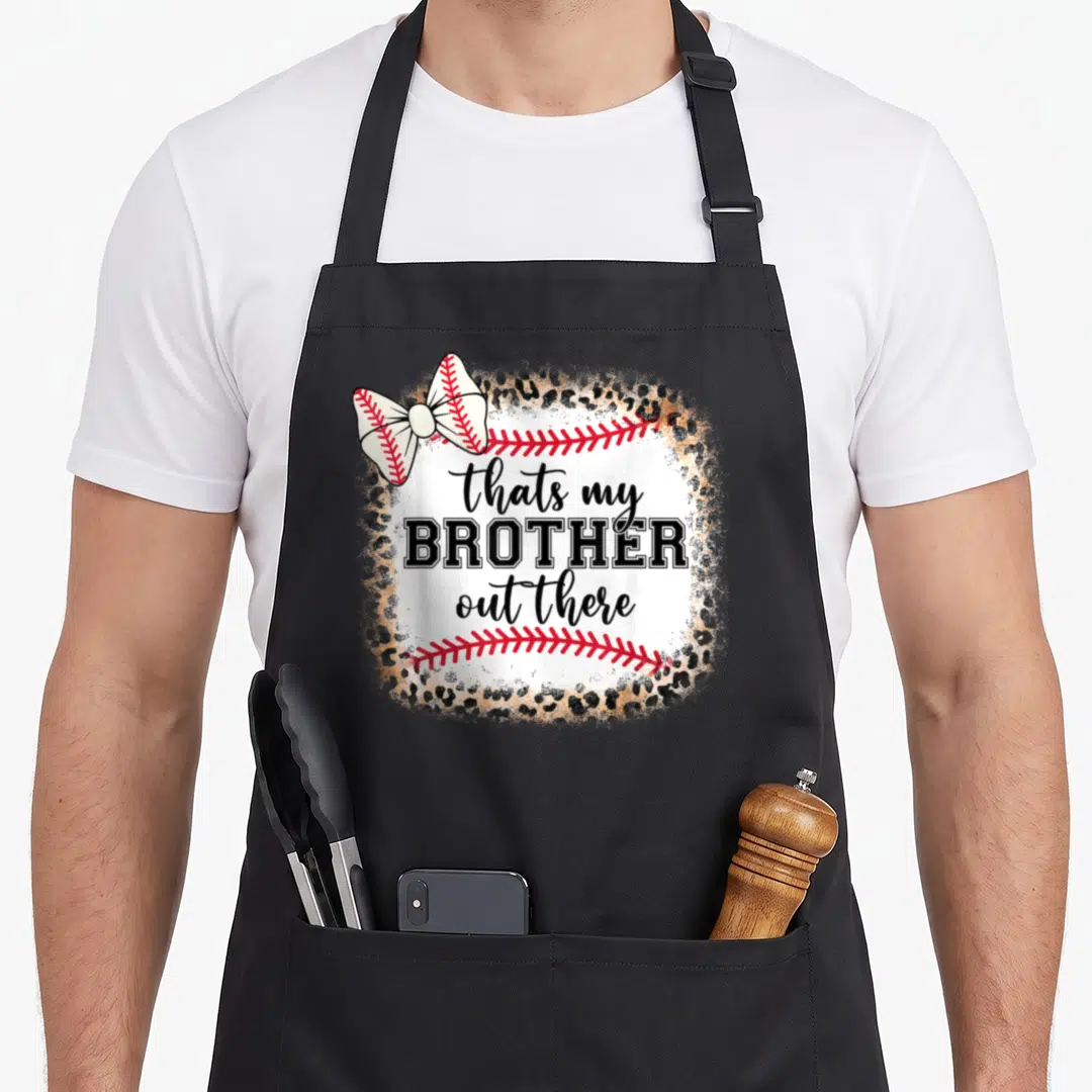 Brother baseball apron - leopard border surrounds white baseball with bow and text thats my BROTHER out there — shown on a black cotton canvas apron against a white background