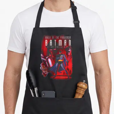 Phantasm cover apron - Batman Mask of the Phantasm text with red spray paint background and character faces — shown on a black cotton canvas apron against a white background