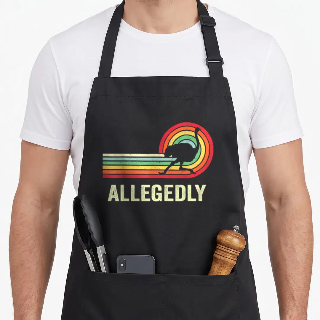 Funny allegedly ostrich lover apron - Grey ostrich silhouette over curved multi-colored stripes with ALLEGEDLY text — shown on a black cotton canvas apron against a white background