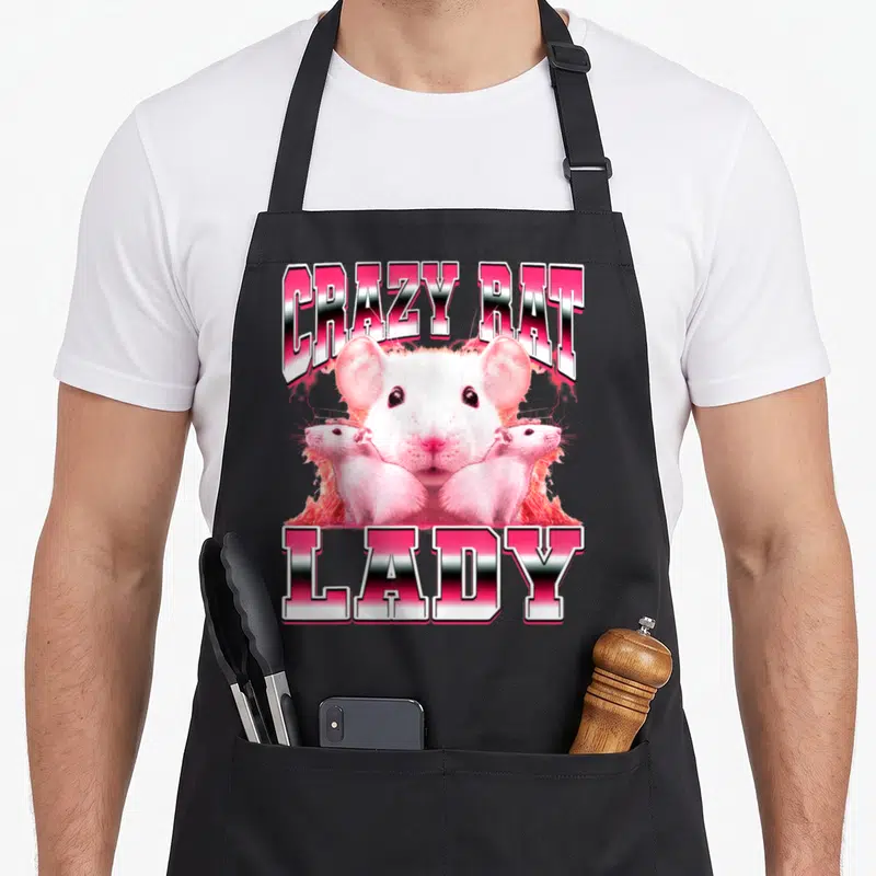 Mouse 90s apron - CRAZY RAT LADY text with three realistic white rats in pink and white gradients — shown on a black cotton canvas apron against a white background