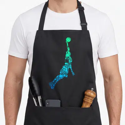 Dunking basketball apron - Jumping player silhouette formed by green and blue basketball icons in minimalist collage — shown on a black cotton canvas apron against a white background