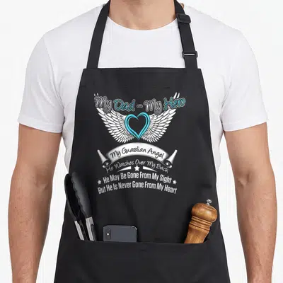 Funny hero angels and aprons - Winged heart with white and blue text My Dad My Hero My Guardian Angel memorial design — shown on a black cotton canvas apron against a white background