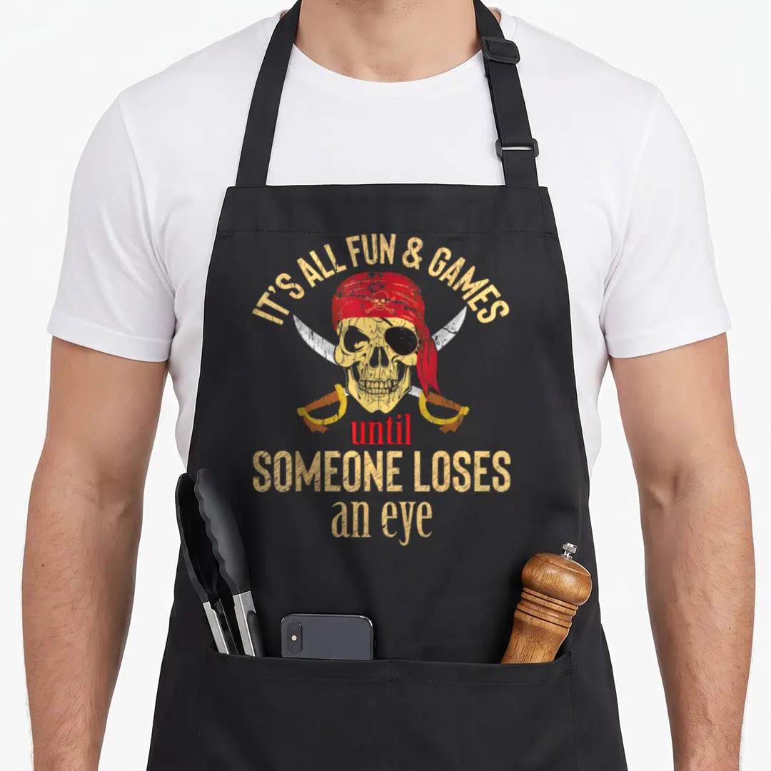 Eye pirate apron - Distressed skull with red bandana, black eye patch, two crossed swords, and sarcastic pirate quote — shown on a black cotton canvas apron against a white background