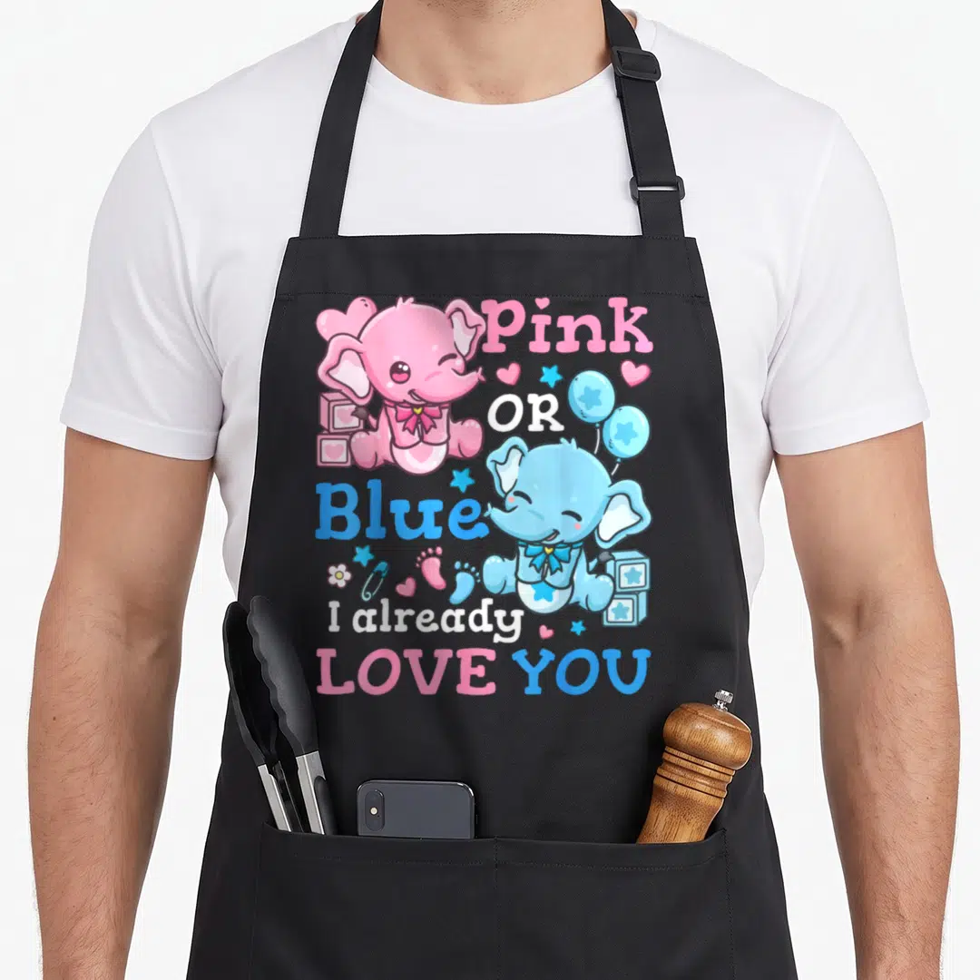 Reveal blue apron or apron - Pink and blue elephants with 'Pink OR Blue I already LOVE YOU' text and baby icons — shown on a black cotton canvas apron against a white background