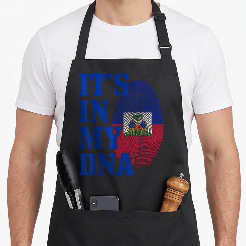Dna fingerprint pride apron - Stacked IT'S IN MY DNA text beside a blue red and white fingerprint with a central emblem — shown on a black cotton canvas apron against a white background