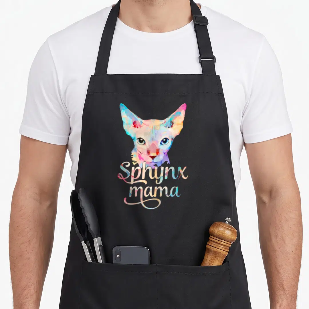 Funny sphynx cat apron - Watercolor sphynx cat head above script text in blue, pink, yellow, and purple — shown on a black cotton canvas apron against a white background