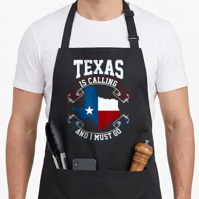 Calling texas apron - Texas map filled with flag colors and text on ribbons — shown on a black cotton canvas apron against a white background