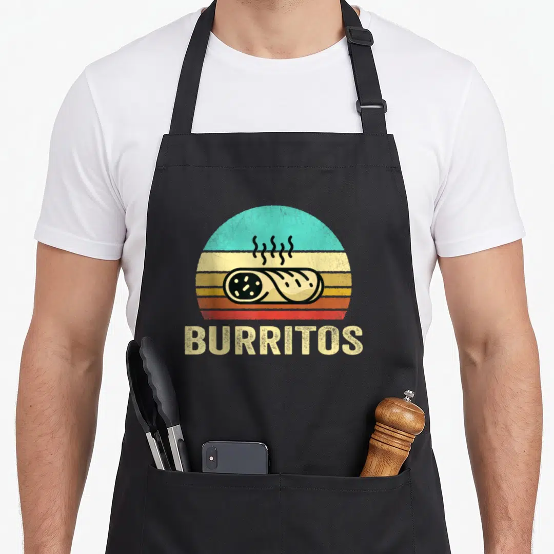 Sunset burritos apron - Retro striped sunset graphic with a steaming burrito and bold BURRITOS text below — shown on a black cotton canvas apron against a white background