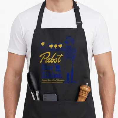 Pabst bartender apron - Retro blue and yellow bartender holding four glasses next to stacked Pabst text and ribbon seal — shown on a black cotton canvas apron against a white background