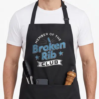 Member rib apron - Blue broken rib bone text with white banner reading Club and two stars on grey background — shown on a black cotton canvas apron against a white background