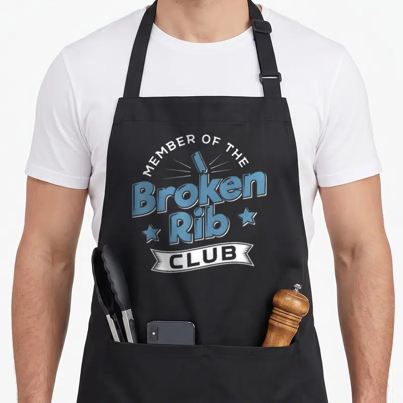 Member rib apron - Blue broken rib bone text with white banner reading Club and two stars on grey background — shown on a black cotton canvas apron against a white background