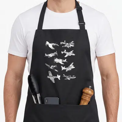 Wwii aircraft apron - Ten white distressed airplanes scattered in various flight angles on grey background — shown on a black cotton canvas apron against a white background