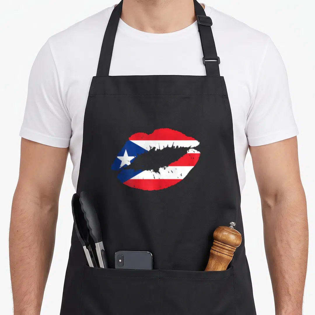 Kiss pride apron - Pair of lips filled with red, white, and blue Puerto Rican flag pattern — shown on a black cotton canvas apron against a white background