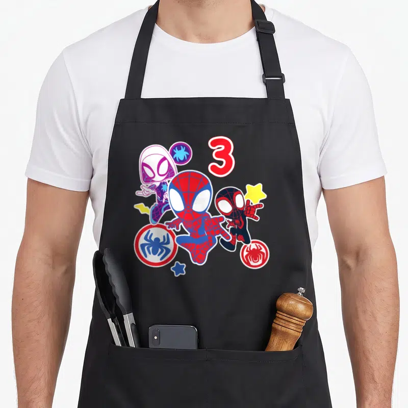 His best friend aprons - Three Spider-Man characters and red number 3 with spider logos in cartoon style — shown on a black cotton canvas apron against a white background