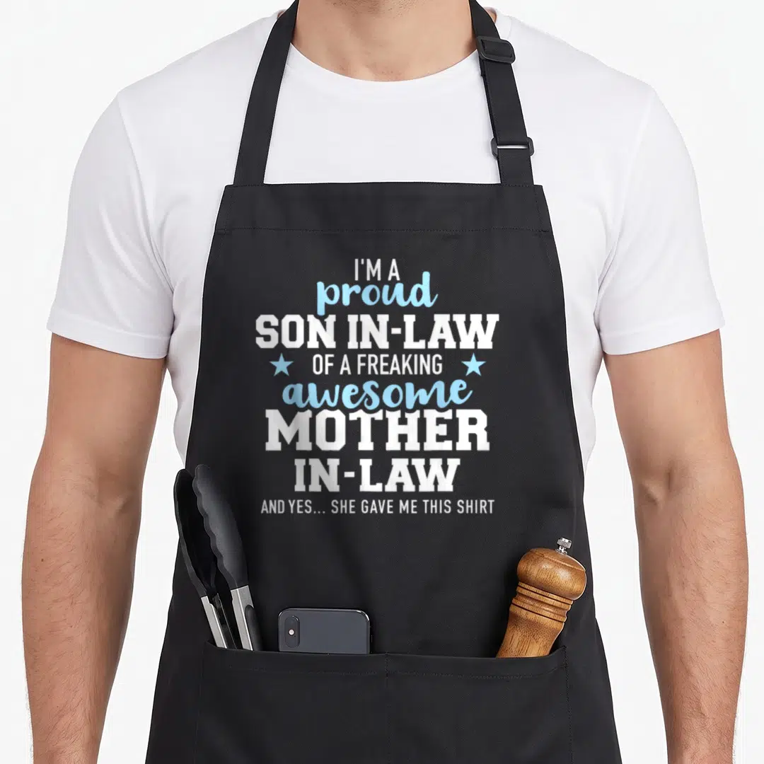 Proud law mother son aprons - Stacked white and blue text reading I'm a proud son in law with two light blue stars — shown on a black cotton canvas apron against a white background