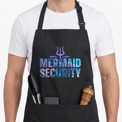 Security family aprons - Purple trident above galaxy patterned MERMAID SECURITY text in blue and white — shown on a black cotton canvas apron against a white background