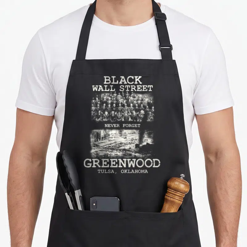 History tulsa apron - Black Wall Street text, group photo, ruins, Never Forget, Greenwood Tulsa — shown on a black cotton canvas apron against a white background