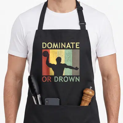 Water polo apron - Retro DOMINATE OR DROWN text with player silhouette over five colored stripes — shown on a black cotton canvas apron against a white background