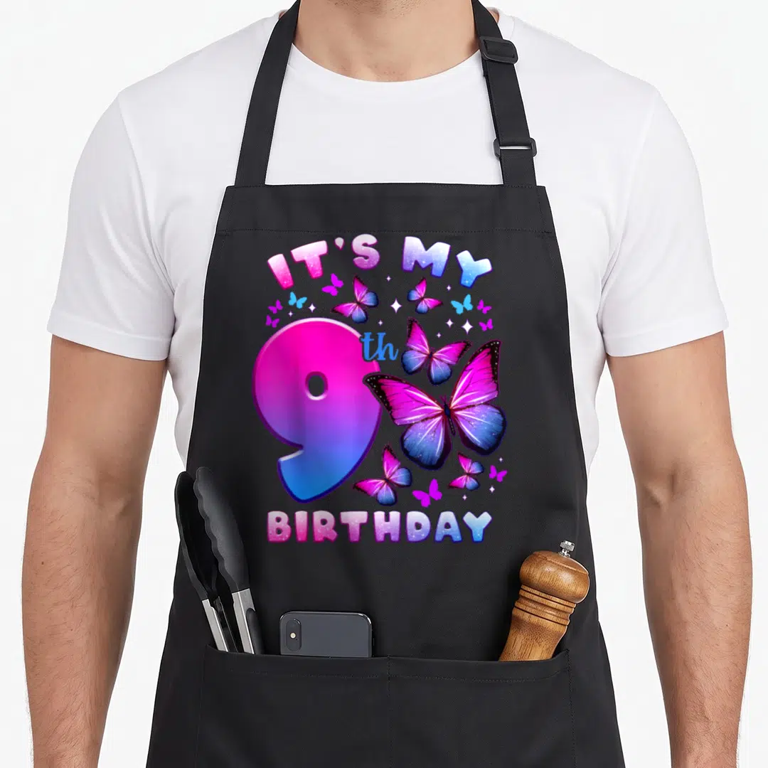 Funny birthday butterfly aprons - Arched IT'S MY 9th BIRTHDAY text with pink blue purple butterflies and stars around — shown on a black cotton canvas apron against a white background