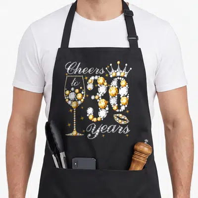 30th wine apron - Gold and white rhinestone text Cheers to 30 Years with champagne glass, crown, and lips — shown on a black cotton canvas apron against a white background