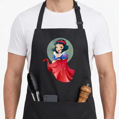 Stylized snow white apron - Cartoon Snow White in red cape and blue dress inside light blue circle — shown on a black cotton canvas apron against a white background