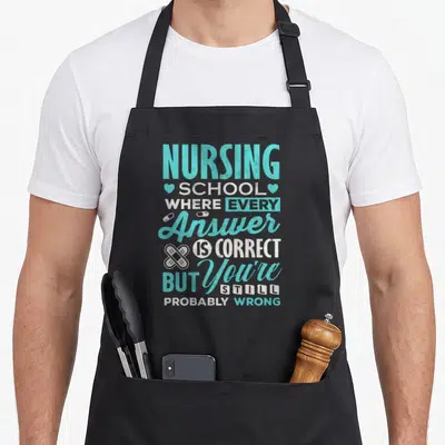 Funny school nursing student apron - Teal and white stacked text with hearts pills and bandages on grey background — shown on a black cotton canvas apron against a white background