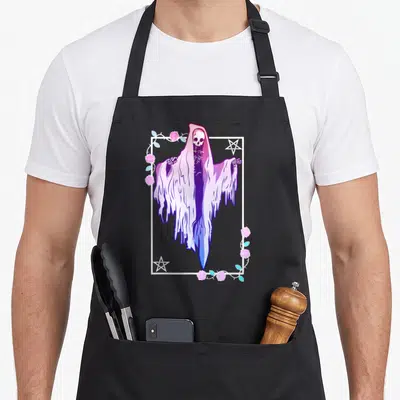 Ghost goth apron - Pastel skeleton in tattered cloak inside white frame with roses and two pentagrams in corners — shown on a black cotton canvas apron against a white background