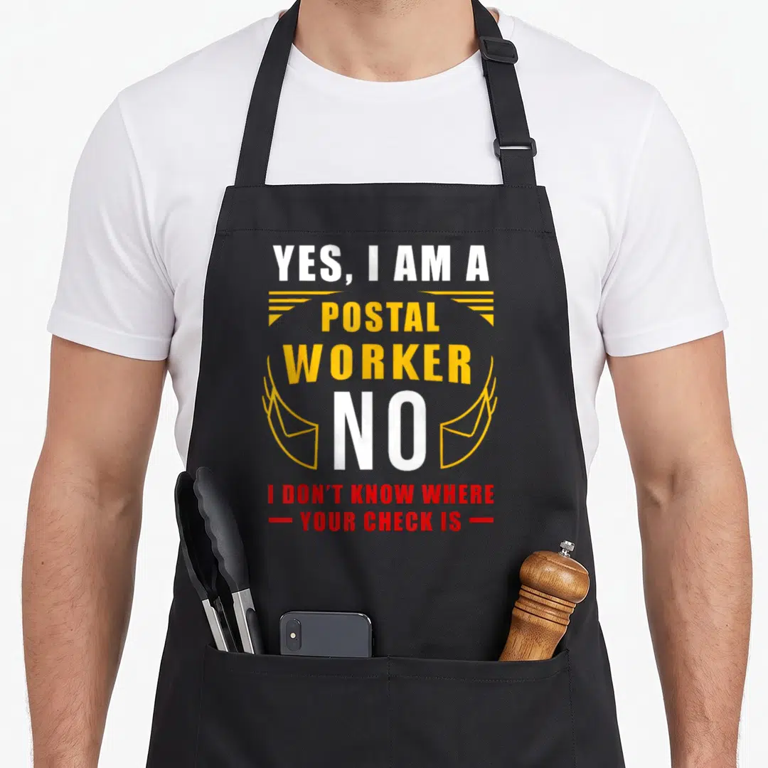 Post retirement apron - Stacked white yellow and red text reading yes i am a postal worker no i dont know where your — shown on a black cotton canvas apron against a white background