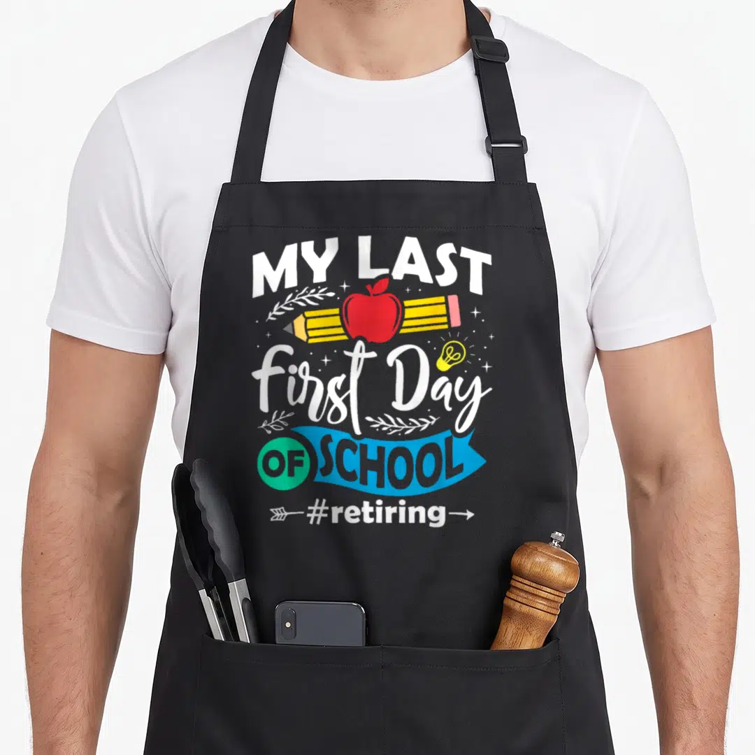 Retiring teacher apron - Stacked text My Last First Day OF SCHOOL with apple pencil and lightbulb in white blue red — shown on a black cotton canvas apron against a white background