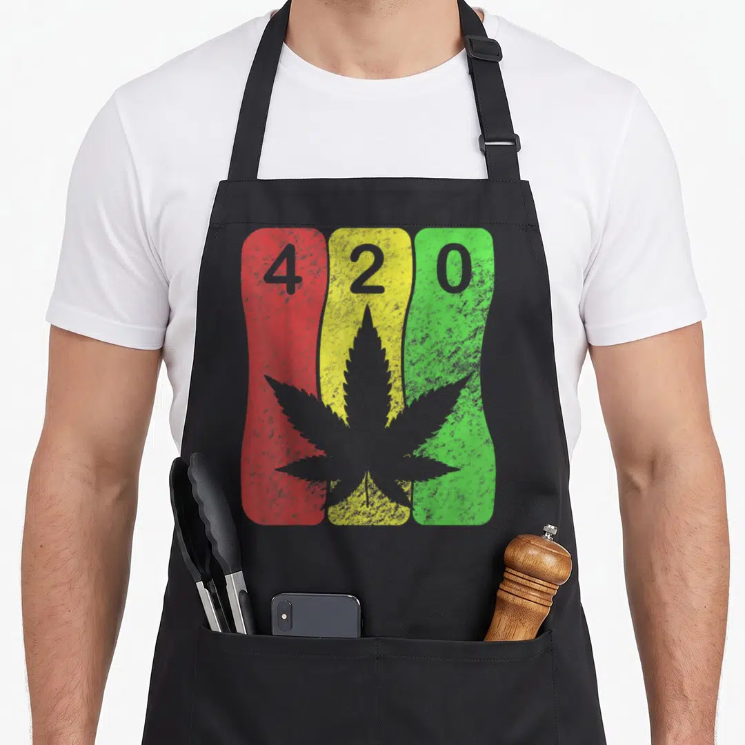 Cannabis hemp apron - Grey 420 text and cannabis leaf on red yellow green wavy bands — shown on a black cotton canvas apron against a white background