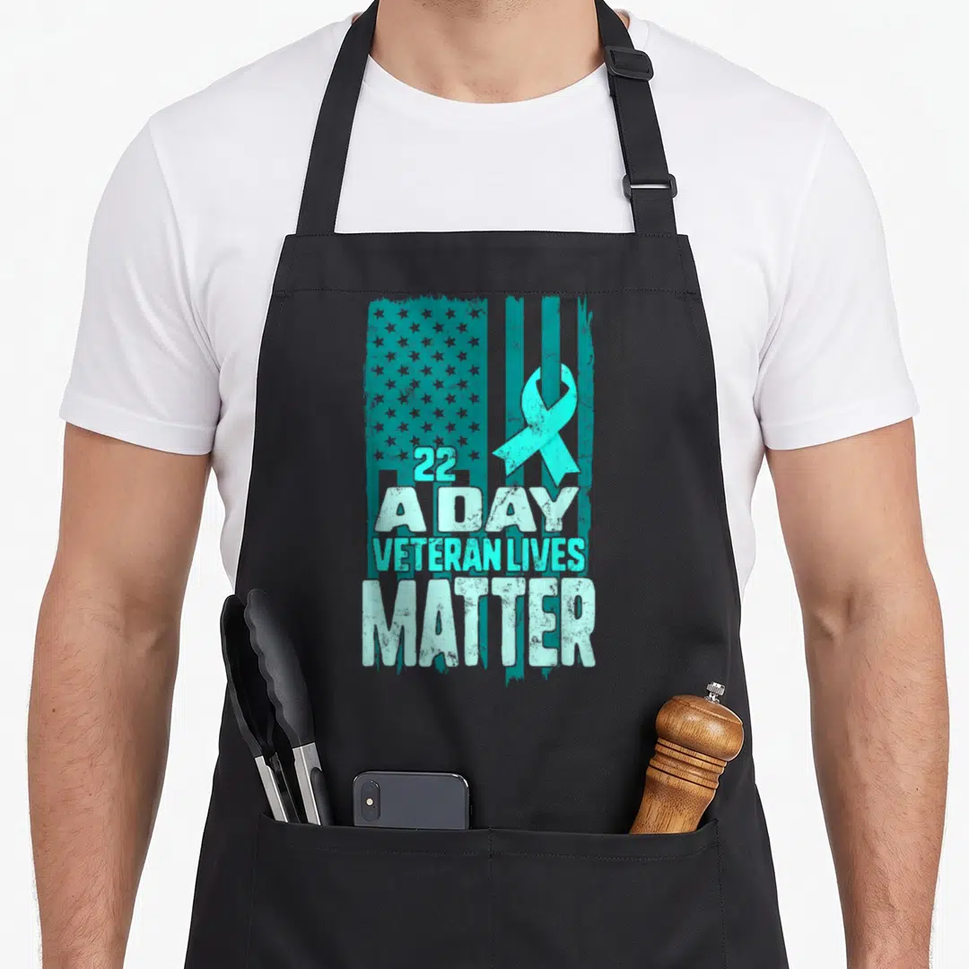 Live american flag apron - Teal distressed US flag with white text 22 A DAY VETERAN LIVES MATTER and teal awareness — shown on a black cotton canvas apron against a white background