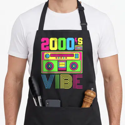 Early hip apron - Neon 2000s Vibe boombox graphic with pink yellow blue green lettering — shown on a black cotton canvas apron against a white background
