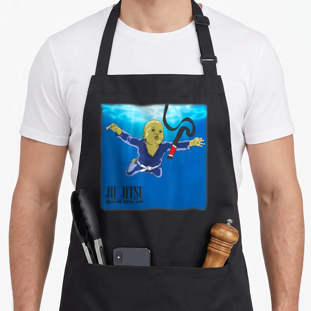 Bjj youll never apron - Cartoon baby in blue gi floating underwater with swirling black belt and text — shown on a black cotton canvas apron against a white background