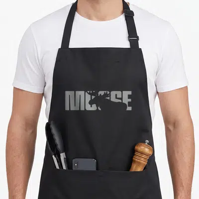 Vintage moose apron - Grey moose silhouette overlapping the word MOOSE in block letters — shown on a black cotton canvas apron against a white background