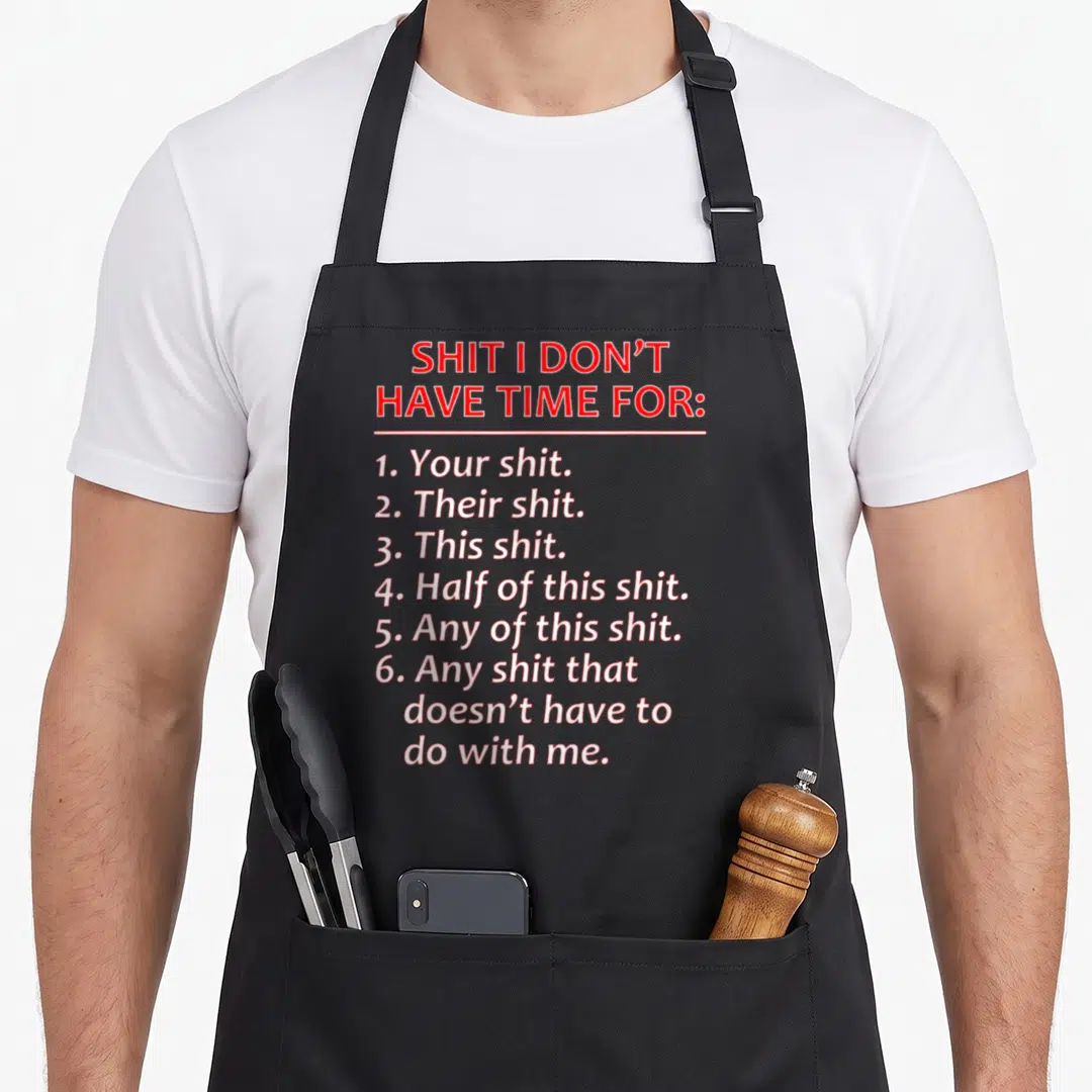 Mocking bull apron - Red and white typography listing six types of nonsense on a black background — shown on a black cotton canvas apron against a white background