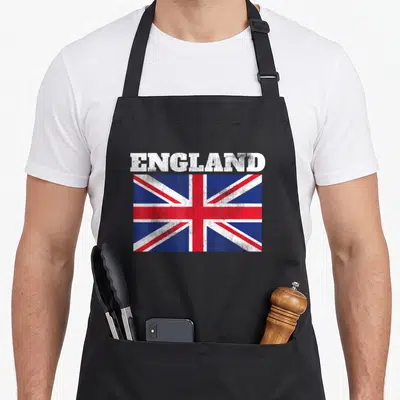 England pride apron - Distressed Union Jack flag with ENGLAND text in white, red, and blue — shown on a black cotton canvas apron against a white background