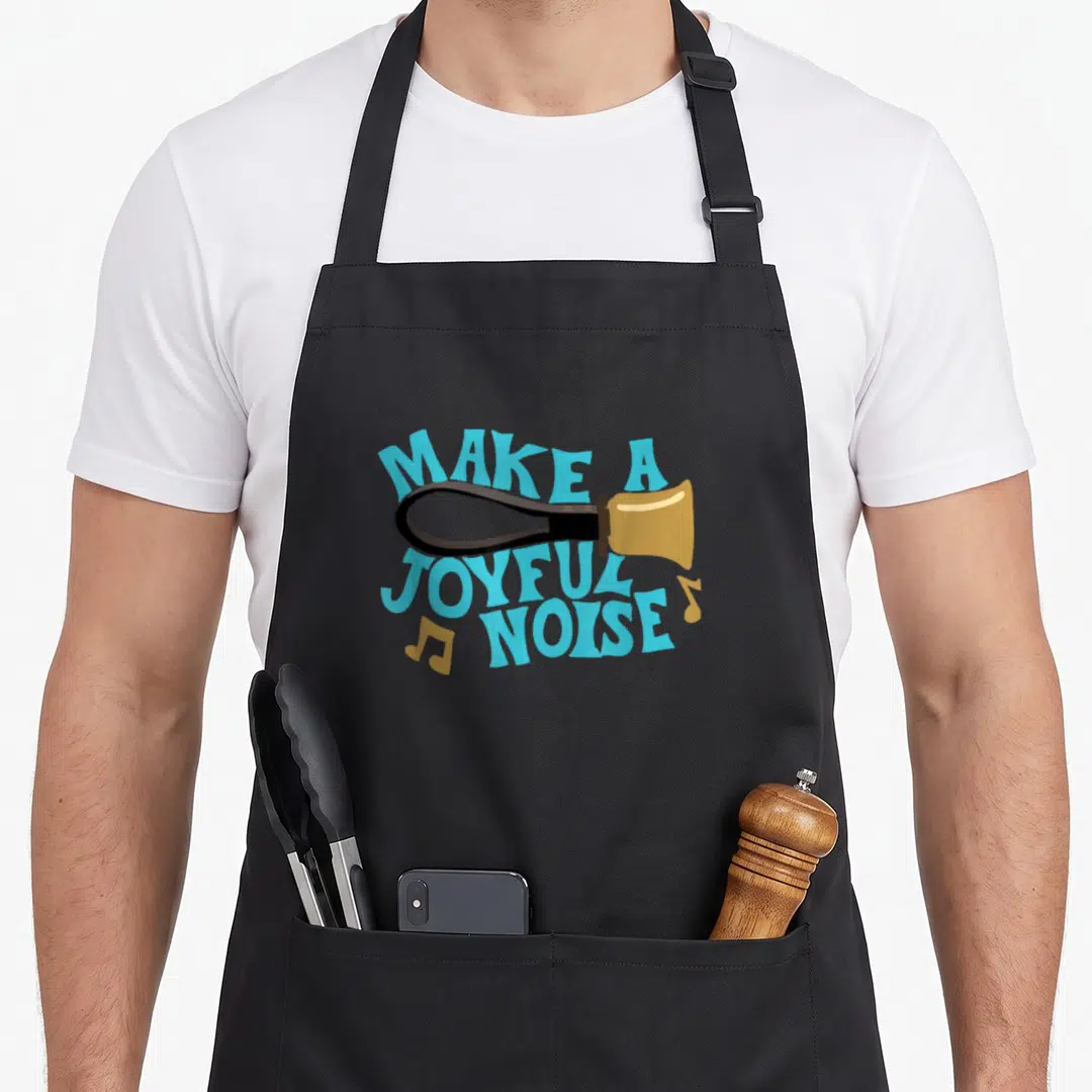 Handbell choir apron - Cartoon gold handbell with blue MAKE A JOYFUL NOISE text and scattered music notes — shown on a black cotton canvas apron against a white background