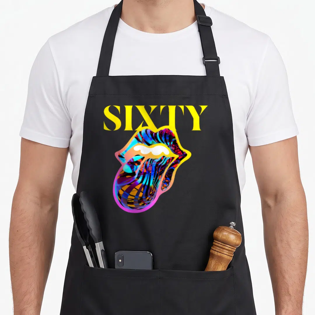 Sixty rolling stones apron - Yellow SIXTY text above multicolored mouth and tongue in cartoon style — shown on a black cotton canvas apron against a white background