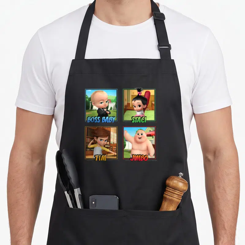 Funny squad boss apron - Four cartoon baby characters named Boss Baby, Staci, Tim, and Jimbo in colored square frames — shown on a black cotton canvas apron against a white background