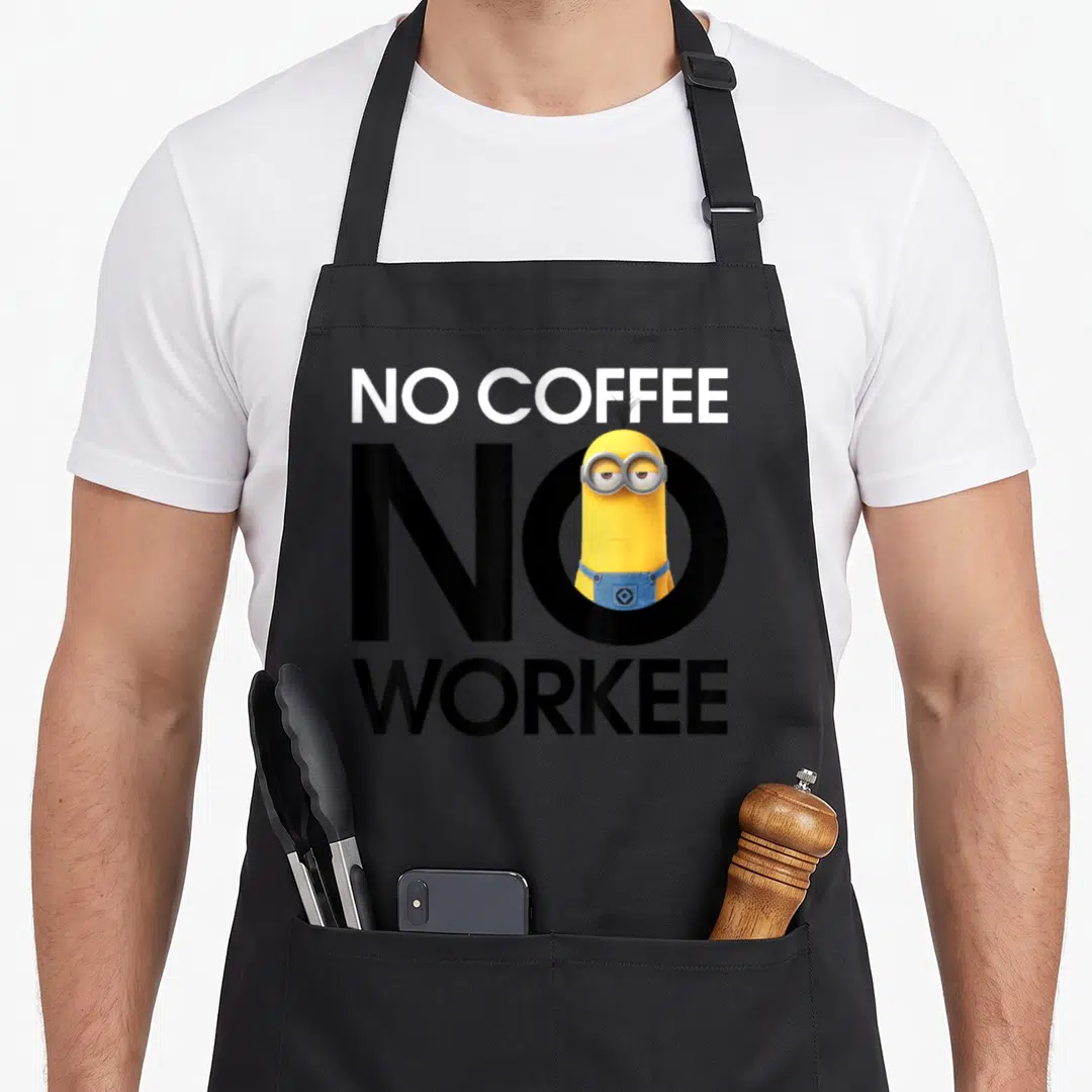 Despicable coffee apron - Minion character inside black letter O with white NO COFFEE and black WORKEE text — shown on a black cotton canvas apron against a white background