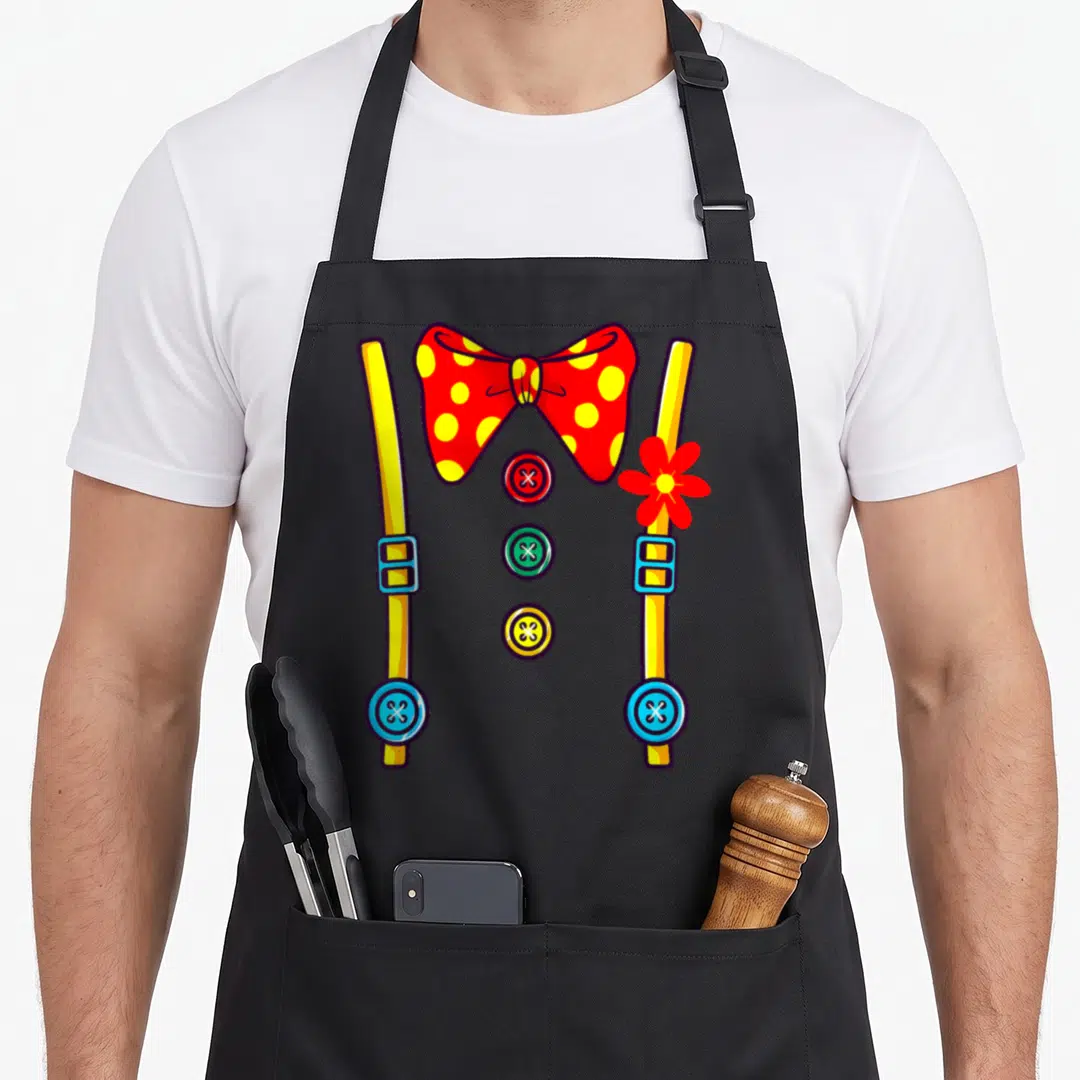 Clown funny halloween apron - Cartoon red bow tie, yellow suspenders, and three colorful buttons in a circus style — shown on a black cotton canvas apron against a white background