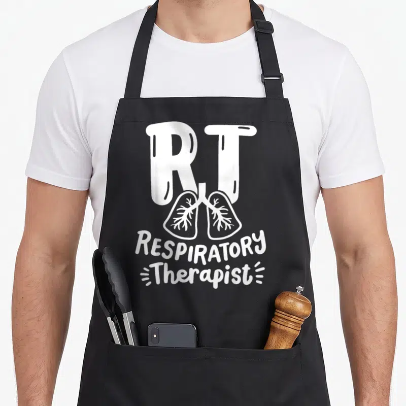 Squad modern apron - White cartoon lungs with RT and RESPIRATORY Therapist text — shown on a black cotton canvas apron against a white background