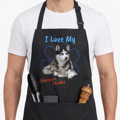 Siberian paw print apron - Realistic husky with I Love My text and blue flower outline — shown on a black cotton canvas apron against a white background