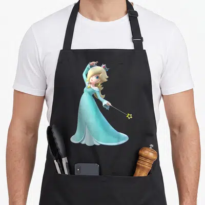 Rosalina holiday apron - Cartoon blonde character in blue gown holding a wand with a yellow star tip — shown on a black cotton canvas apron against a white background