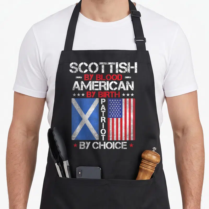 Birth blood apron - Two flags with stacked SCOTTISH AMERICAN PATRIOT text in distressed white red blue — shown on a black cotton canvas apron against a white background
